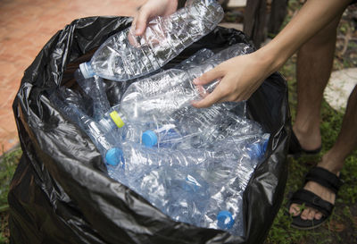 High angle view of man collecting plastic bottles