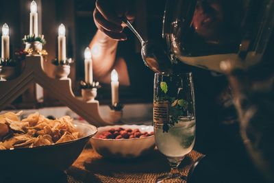 Candlelight dinner. preparing a glass of lemon soda