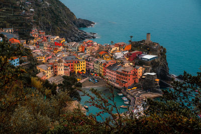 High angle view of townscape by sea against sky