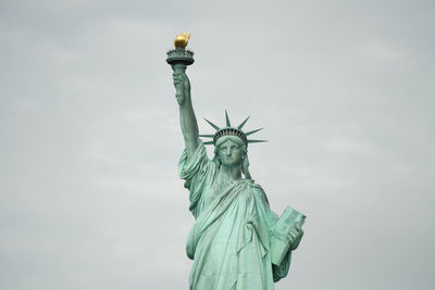 Low angle view of statue of liberty against sky