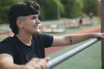 Young woman exercising at outdoor gym