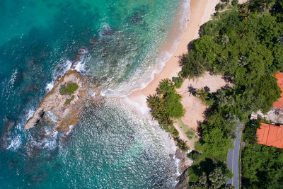 High angle view of swimming pool by sea against trees