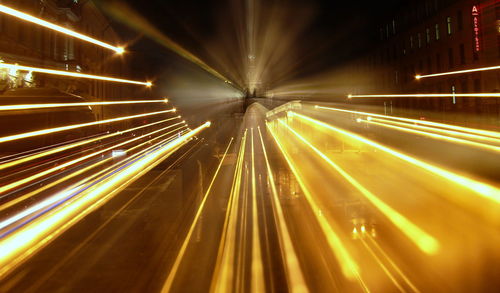 Light trails on street against orthodox church at night