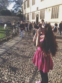 Women standing on cobblestone street