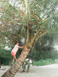 Side view of woman standing by plants