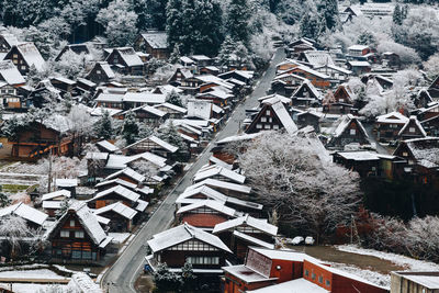 High angle view of snow covered houses in city