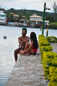 Couple sitting by lake