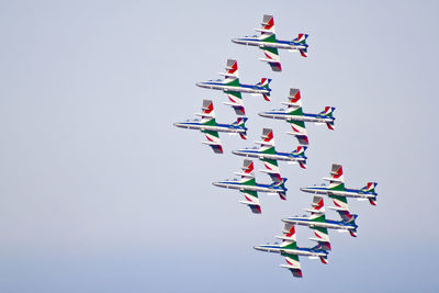 Low angle view of airshow against clear sky