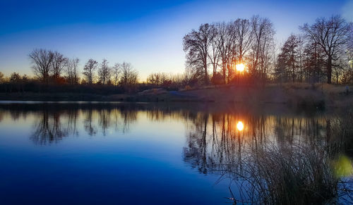 Scenic view of lake against sky during sunset