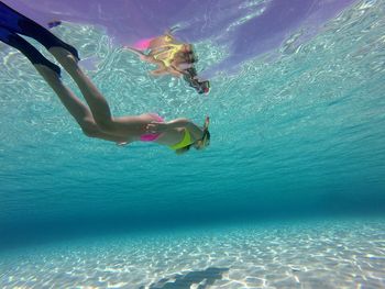 Low section of woman swimming in sea