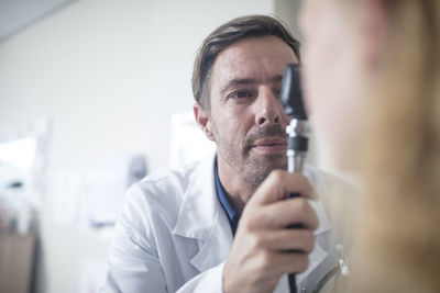 Doctor using an otoscope