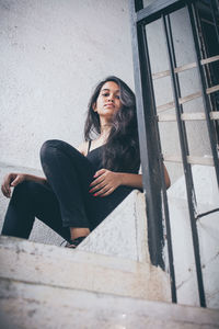 Portrait of young woman sitting on steps