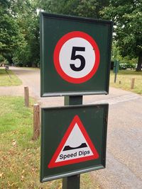 Close-up of signboard on road