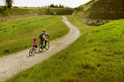 Man riding bicycle on field