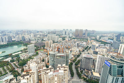 High angle view of modern buildings in city against sky