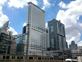 Low angle view of buildings against cloudy sky