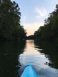 Reflection of trees in water against sky