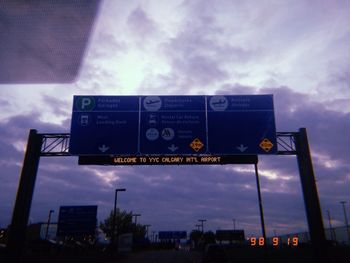 Low angle view of road sign against sky