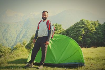 Portrait of young man standing on mountain