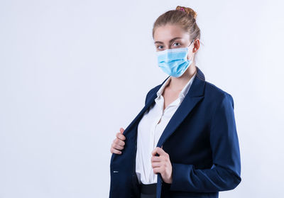 Portrait of woman standing against white background