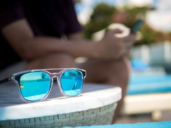 Close-up of sunglasses on swimming pool