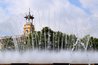 Low angle view of fountain against building