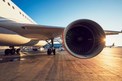 Airplane on runway against sky