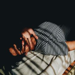 High angle view of man lying on bed