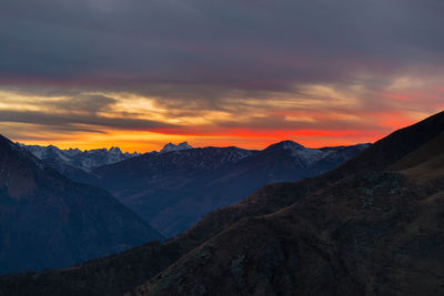 Scenic view of snow covered mountains during sunset