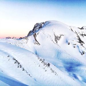 Close-up of snow on mountain against sky