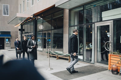 People walking in front of building