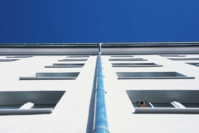 Low angle view of building against clear blue sky