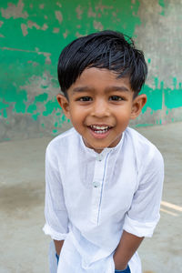 Portrait of smiling boy standing outdoors