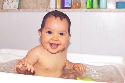 Portrait of cute baby boy in bathroom at home