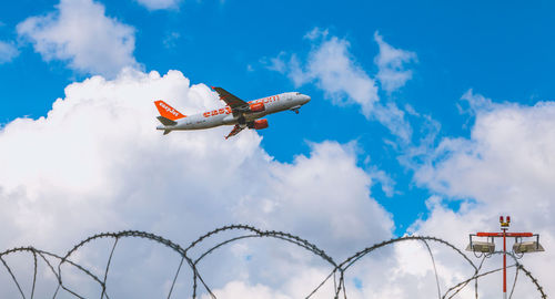 Low angle view of airplane flying in sky