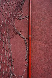 Old soccer goal in the red field on the street