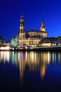Reflection of illuminated buildings in water at night