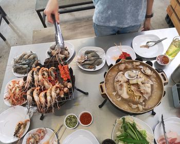 Midsection of man preparing food on table