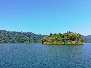 Scenic view of lake against clear blue sky