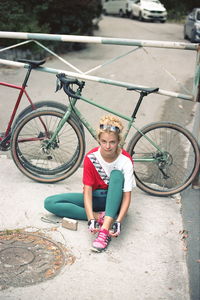 High angle view portrait of girl with bicycle