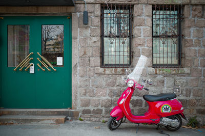 Close-up of motor scooter against building