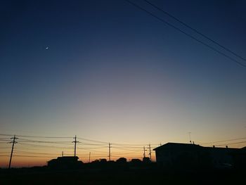 Silhouette built structure against sky during sunset