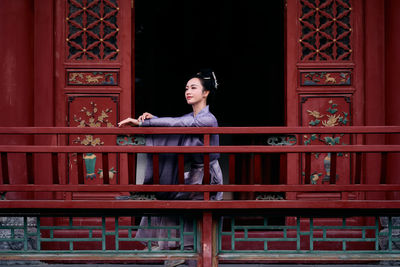 Low angle view of young woman standing in building