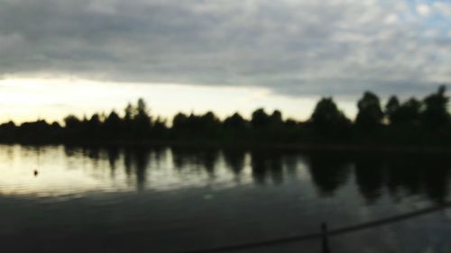 Scenic view of lake against cloudy sky