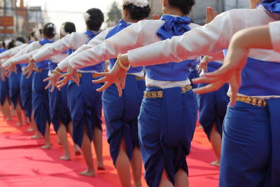 Women dancing on footpath