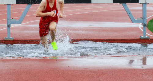 Side view of woman splashing water