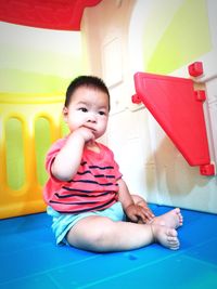 Portrait of boy sitting on table