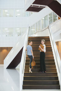 Young women in office building hall