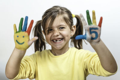 Portrait of smiling girl holding camera