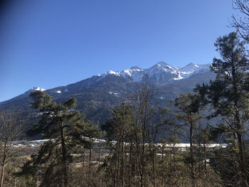 Scenic view of snowcapped mountains against clear sky